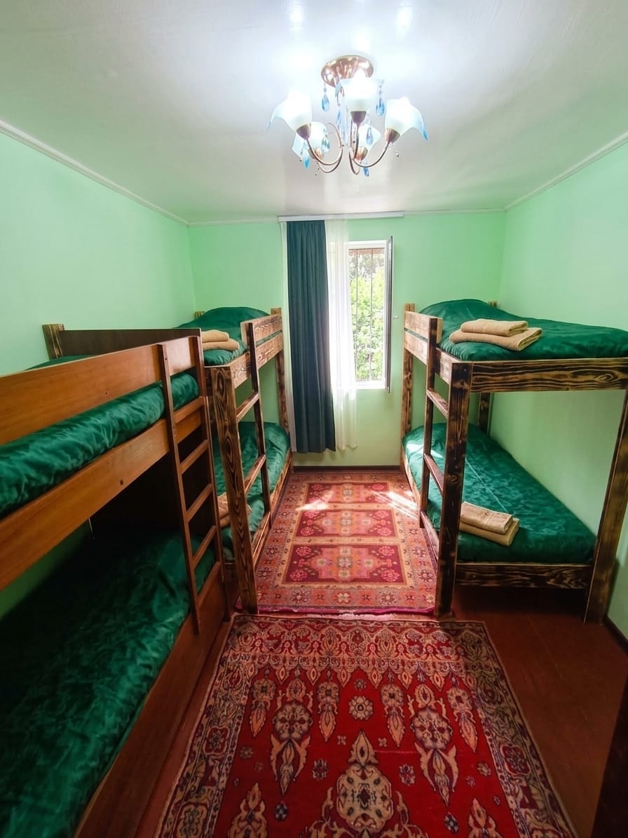 VL Guest House cozy bedroom — warm rustic interior with natural decor