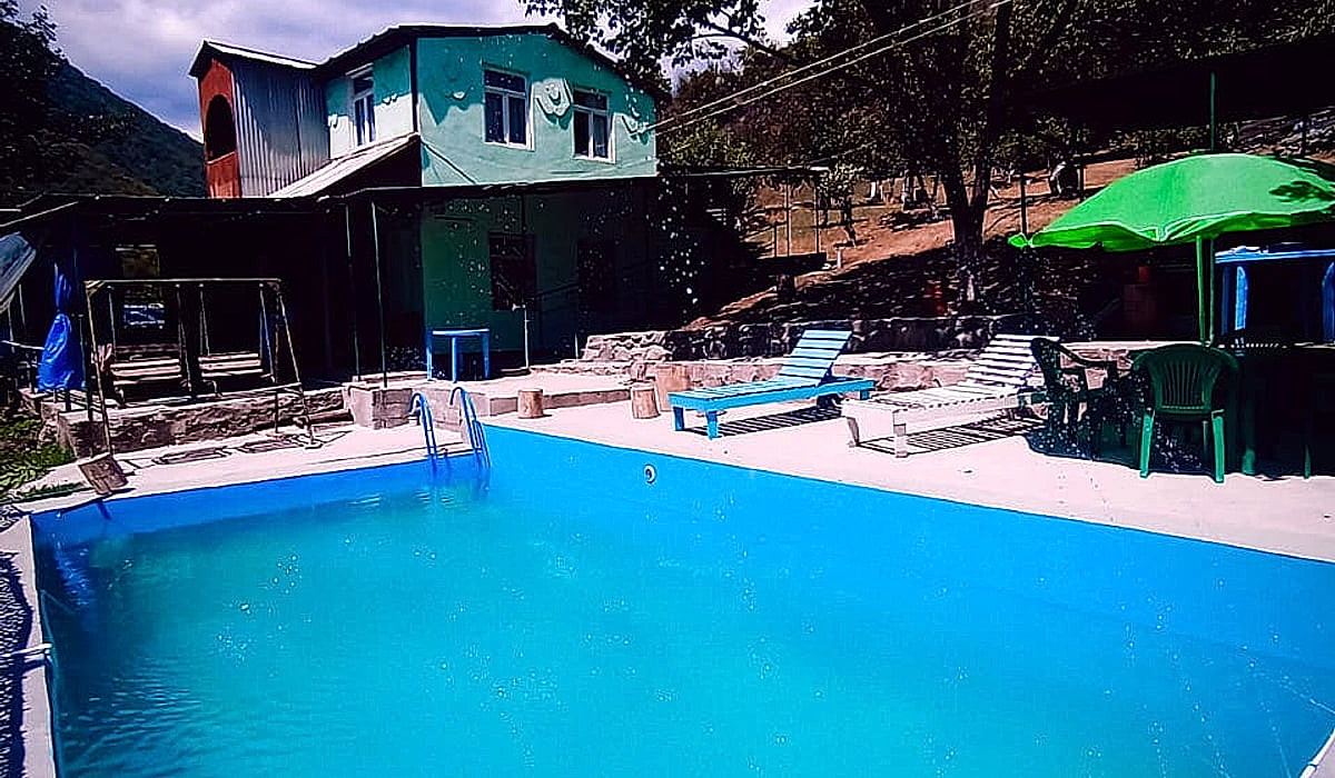 VL Guest House aerial view — family property with infinity pool surrounded by Alaverdi mountains